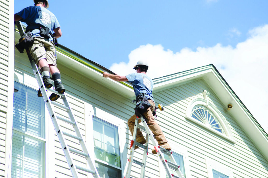 Brother Gutters technician on ladder