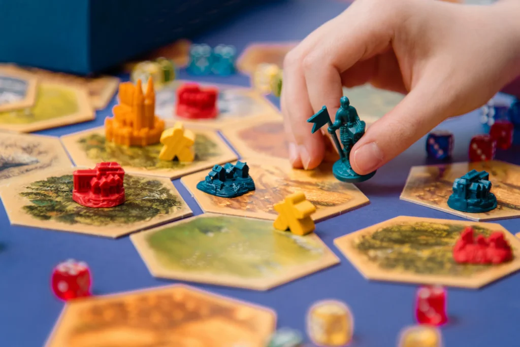 Colorful board game figures and dice on the field, hobby